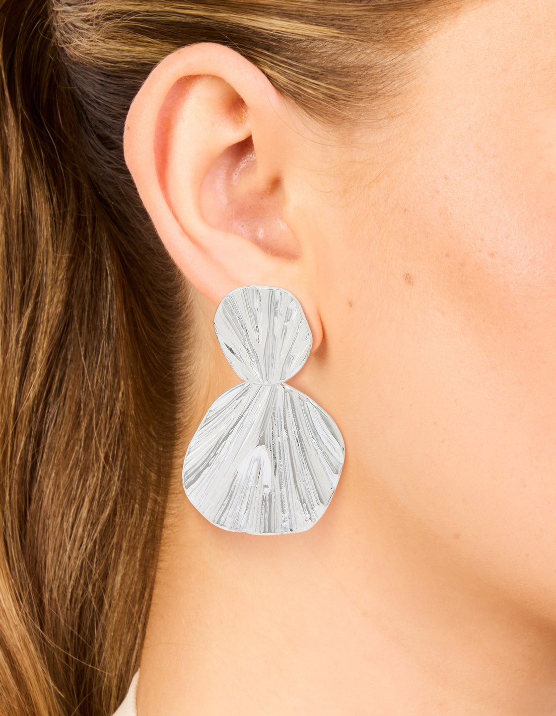 These statement waterproof stainless steel double textured drop earrings in silver on ear view