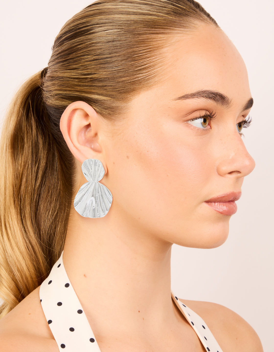 Presenting statement waterproof stainless steel double textured drop earrings in silver on model view
