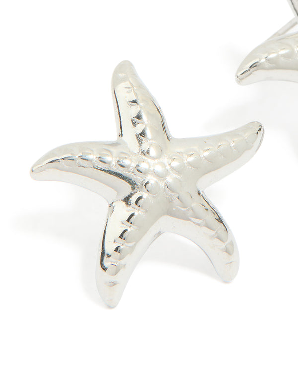 Featuring waterproof stainless steel textured starfish stud earrings with ocean in silver close up view