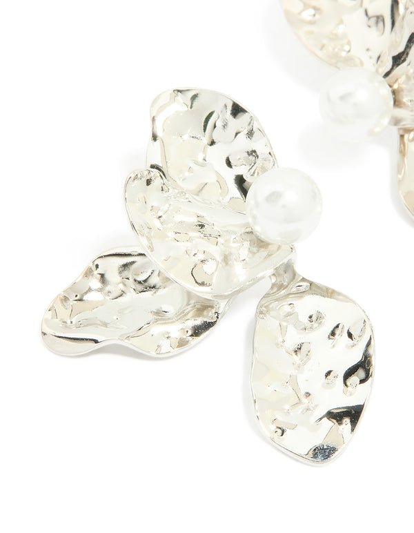 Featuring floral design with pearl details, these waterproof stainless steel large stud earrings in silver and white close up view