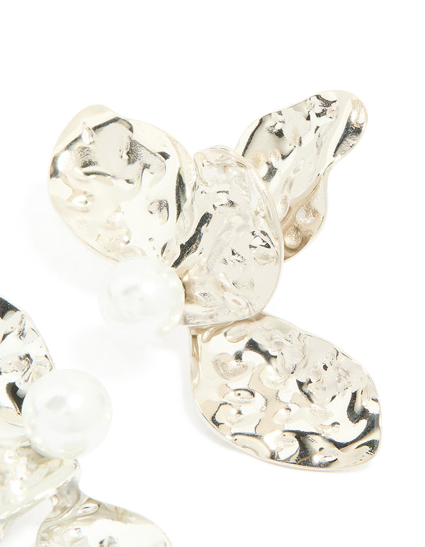 Crafted from waterproof stainless steel with pearl accents, these large flower stud earrings in silver and white post detail view