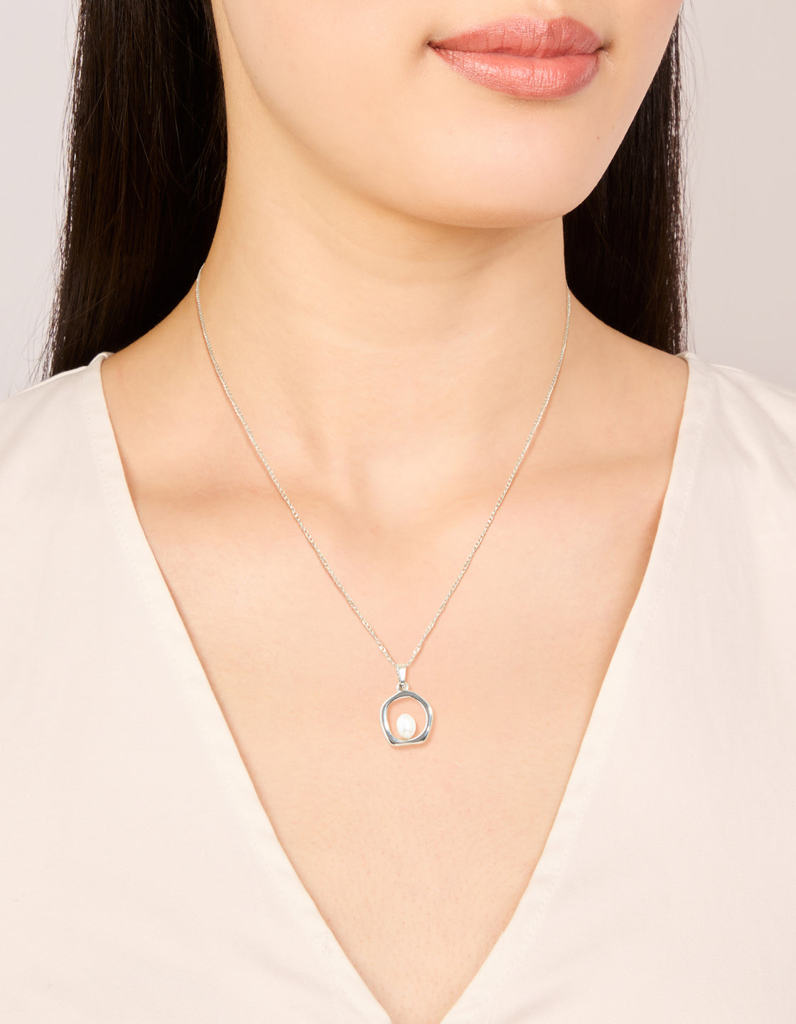 Crafted from stainless steel this waterproof freshwater pearl molten hoop pendant necklace sits elegantly in silver and white on neck view