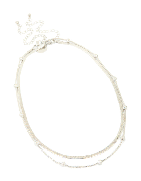Showcase your look with a waterproof stainless steel snake chain and ball charm layered necklace in silver featuring statement design front view