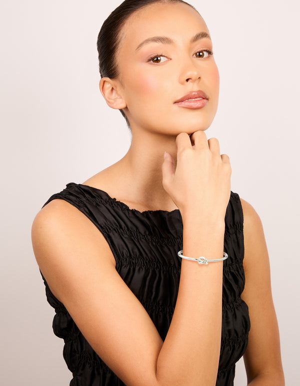 Designed with waterproof stainless steel basic knotted centre wrist cuff in silver on model view