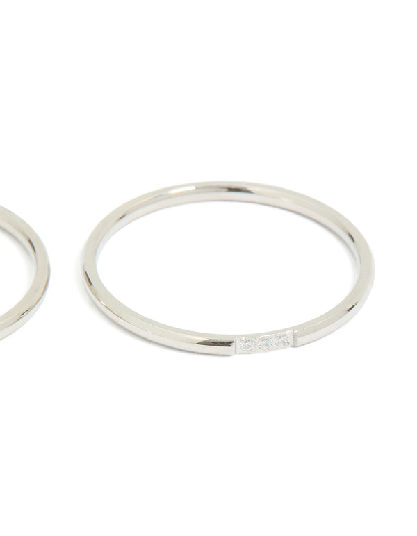 Showcasing waterproof stainless steel thin cubic zirconia trio rings in a 3-pack with silver and clear stone accents close up view
