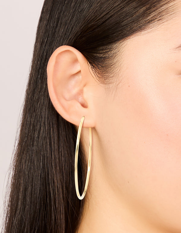 Discover waterproof gold plated stainless steel hoop earrings in 55 MM size on ear view