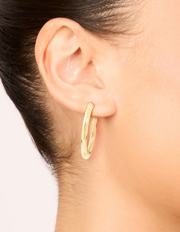 Featuring waterproof gold plated stainless steel hoop earrings on ear view