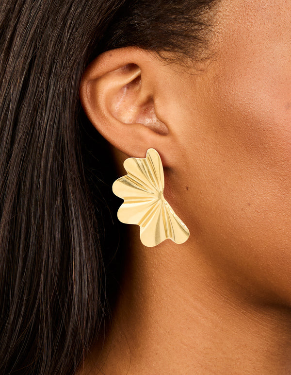Featuring waterproof gold plated stainless steel wavy fan flower stud earrings in gold on ear view