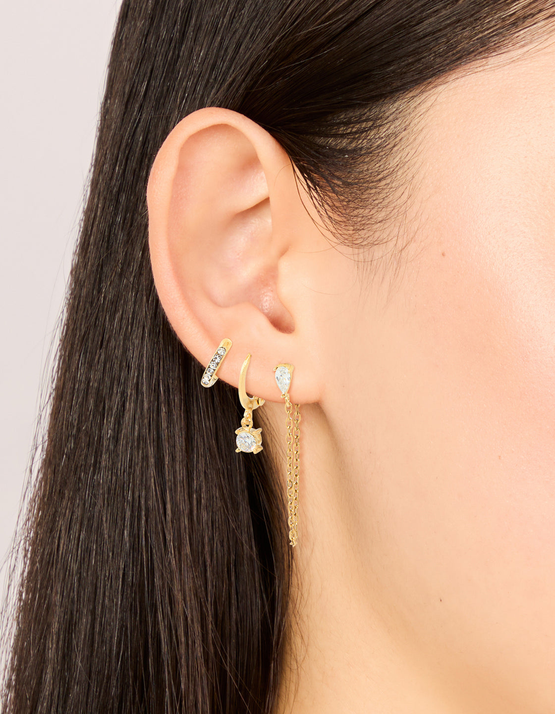 Showcasing waterproof gold plated stainless steel cubic zirconia pavé earrings stacking pack featuring on ear view