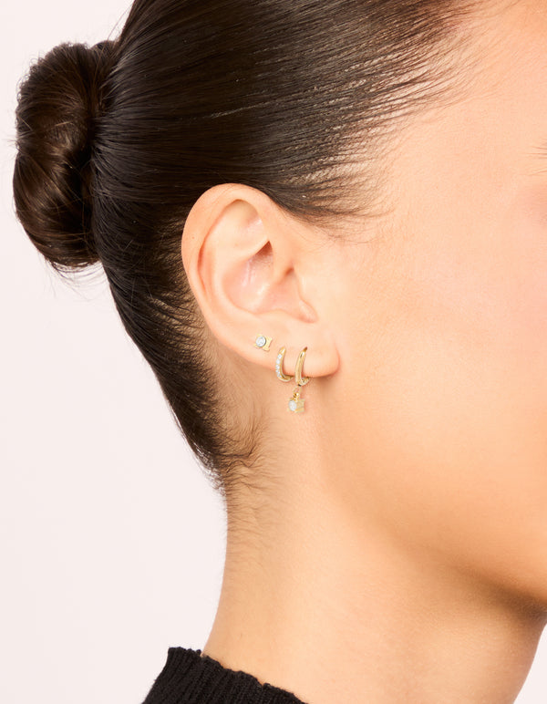 Discover waterproof gold plated stainless steel diamante earrings with stud and huggie closures in a 3-pack on ear view