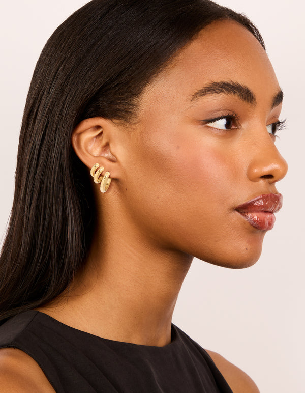 Crafted from waterproof gold plated stainless steel chubby hoop earrings in a 3-pack with chunky style on model view