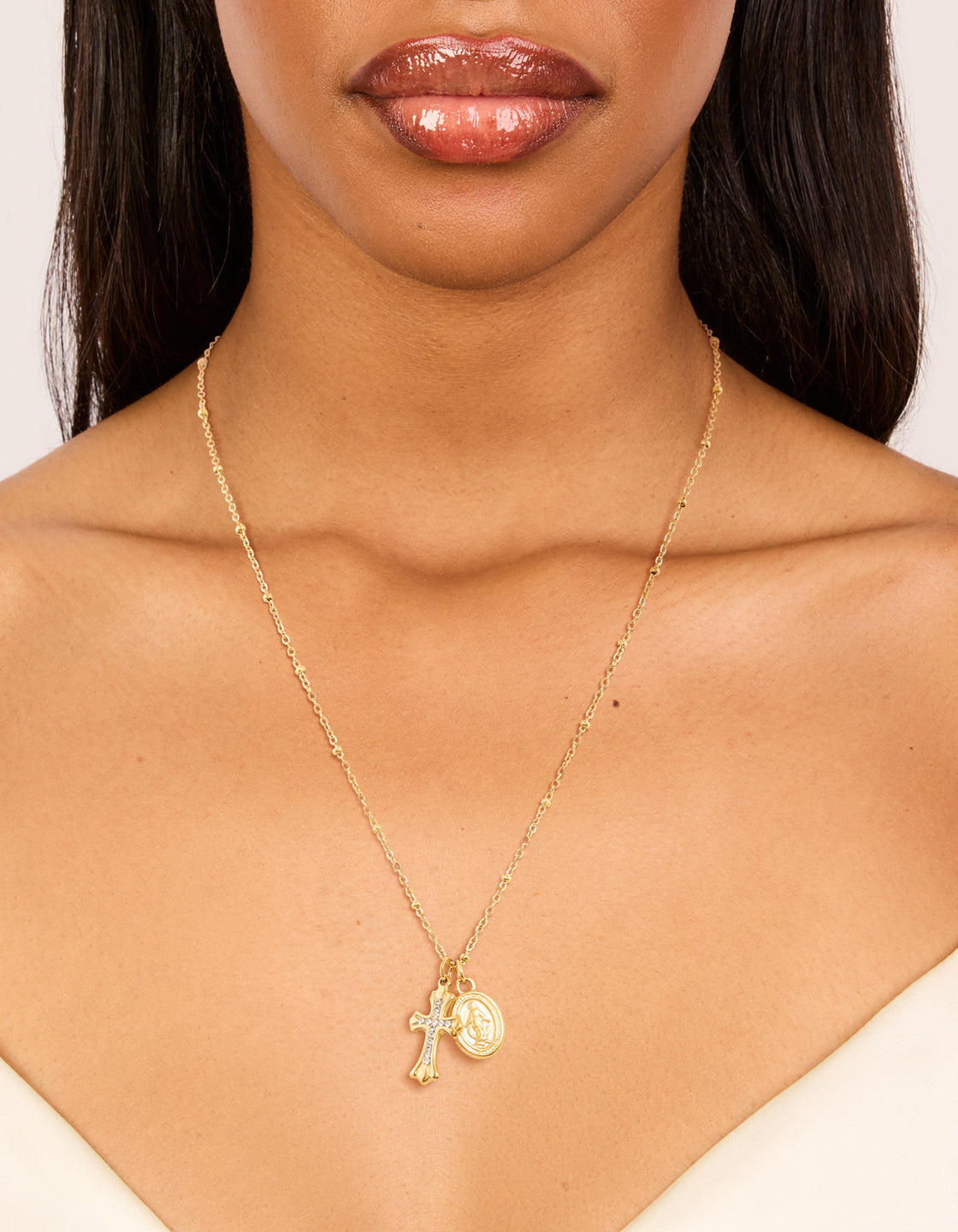Designed with a waterproof gold plated stainless steel Mary and Cross necklace featuring angel coin charm and cross pendant with balls on neck view