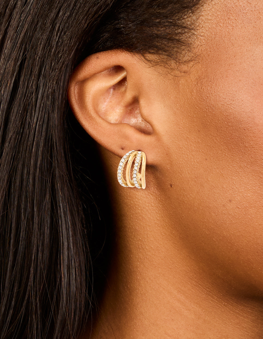 Showcasing waterproof gold plated stainless steel cubic zirconia pave 4-row illusion hoop earrings in statement style on ear view