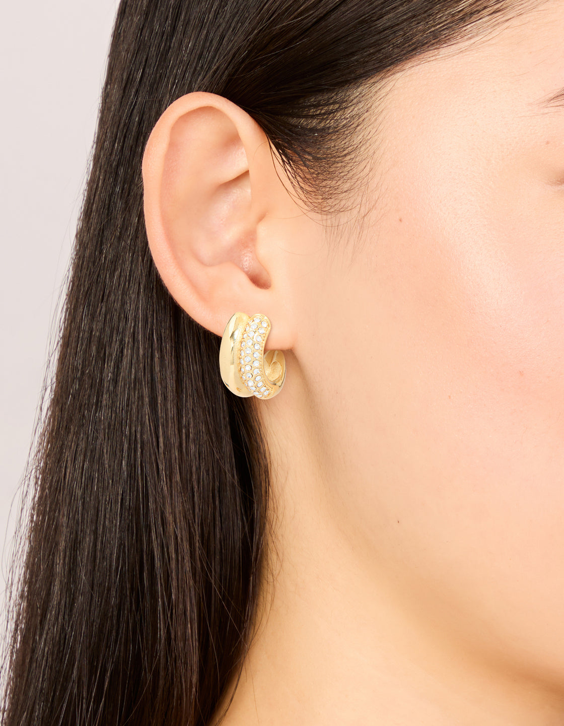 Featuring waterproof gold plated stainless steel cubic zirconia pave illusion hoop earrings on ear view