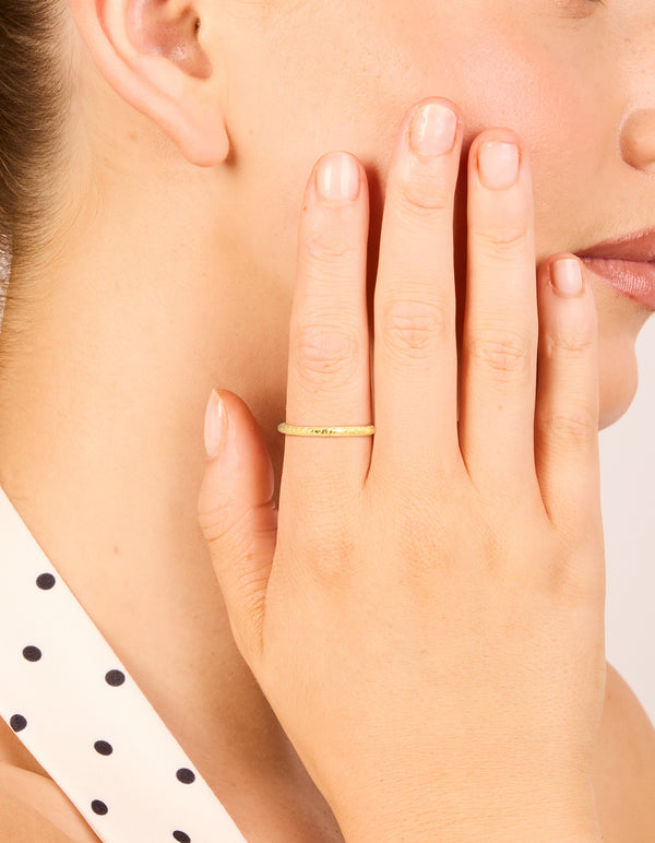 Featuring gold plated sterling silver molten ring with textured band on finger view