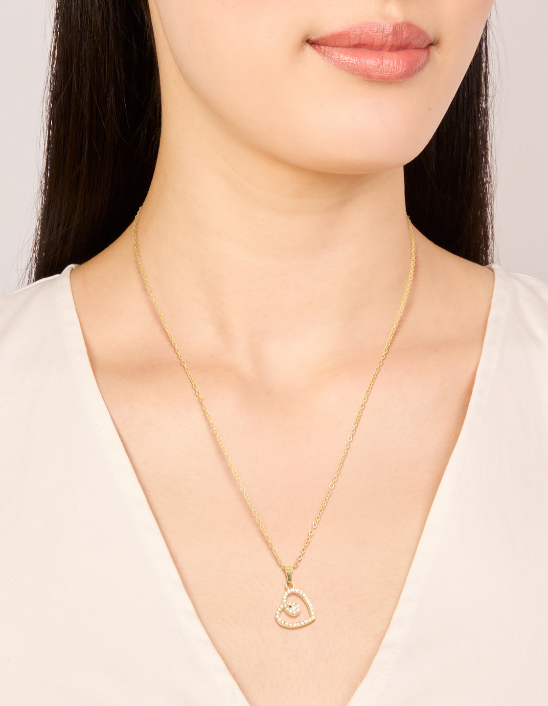 Showcasing a waterproof heart pendant necklace crafted from stainless steel with cubic zirconia in a dainty style on neck view