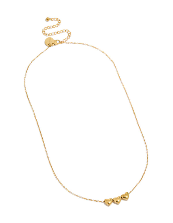 Featuring a waterproof chunky heart trio necklace in gold plated stainless steel with charm design front view