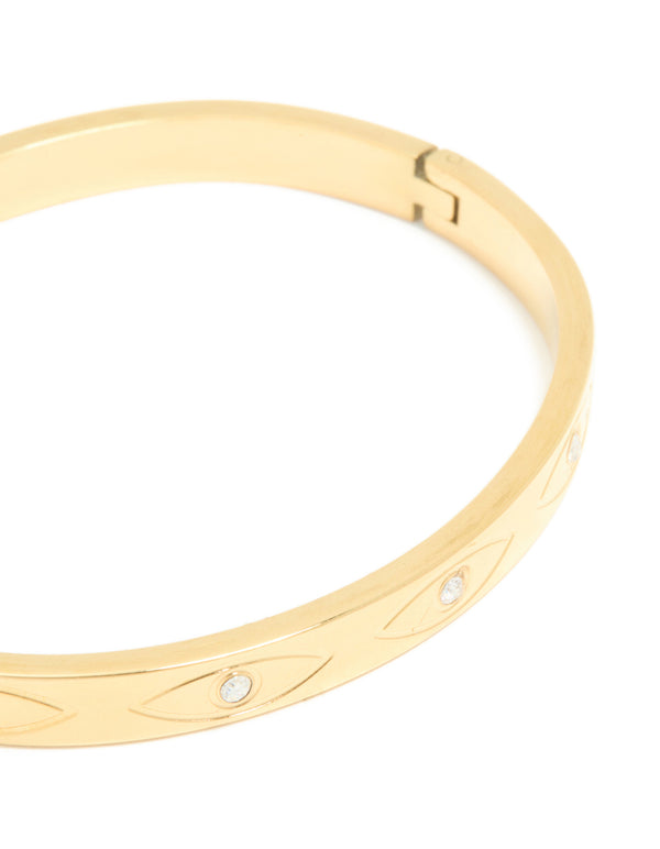 Highlighting a waterproof gold plated stainless steel evil eye bangle with cubic zirconia in statement style close up view