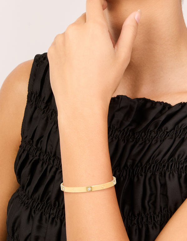 This waterproof gold plated stainless steel cubic zirconia flower bangle showcases elegant design and comfortable fit on wrist view