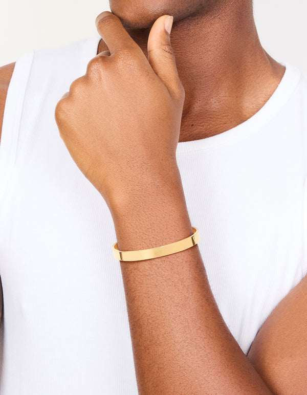 Beautifully designed mens waterproof smooth flat wrist cuff in stainless steel with chunky gold plated finish on wrist view