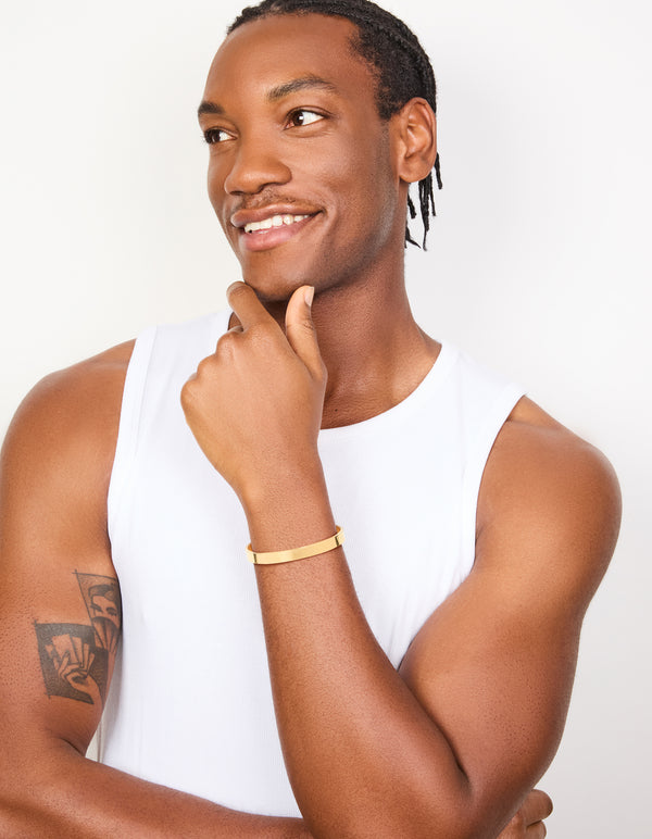 Explore this mens waterproof smooth flat wrist cuff featuring stainless steel with dainty gold plated finish on model view