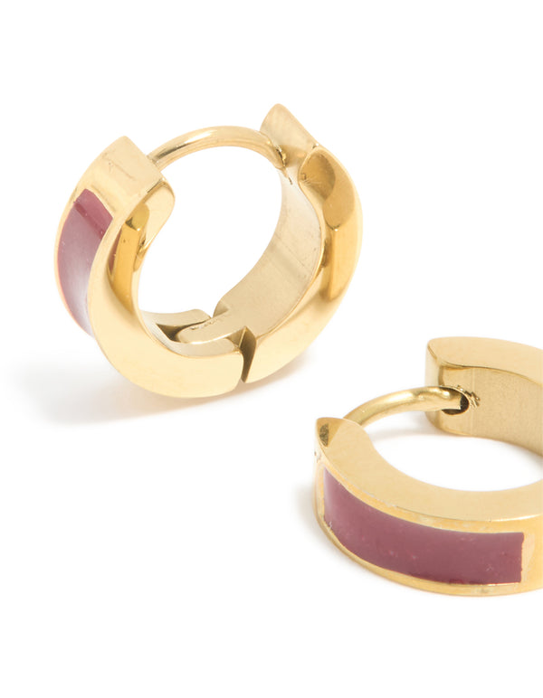 Featuring waterproof gold plated stainless steel construction with burgundy red enamel inlay, these small statement huggie earrings close up view