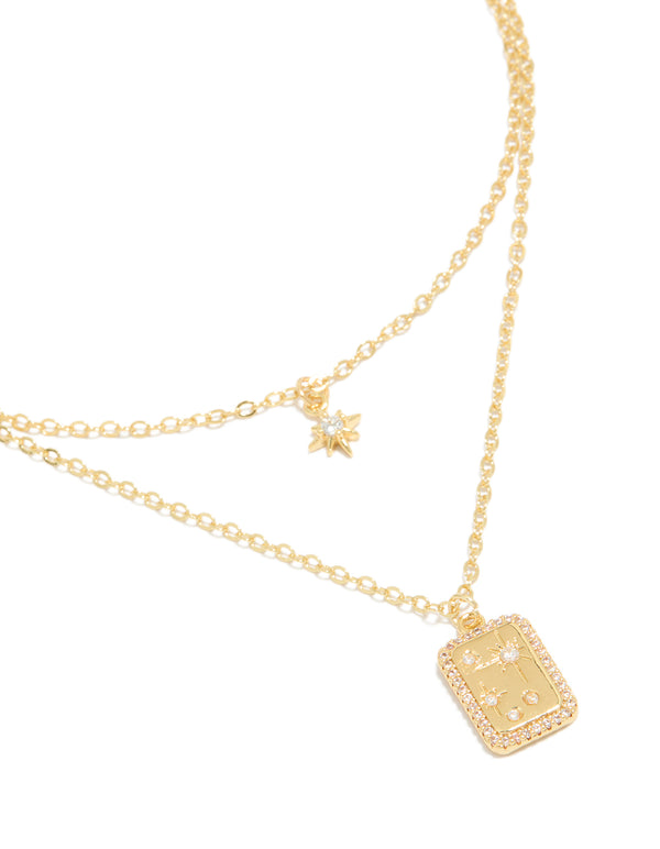 Showcasing a gold plated cubic zirconia celestial and rectangle cluster layered necklace close up view