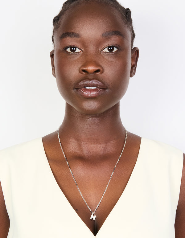 Crafted in waterproof stainless steel mini bubble letter H necklace with initial pendant dainty style silver on model view