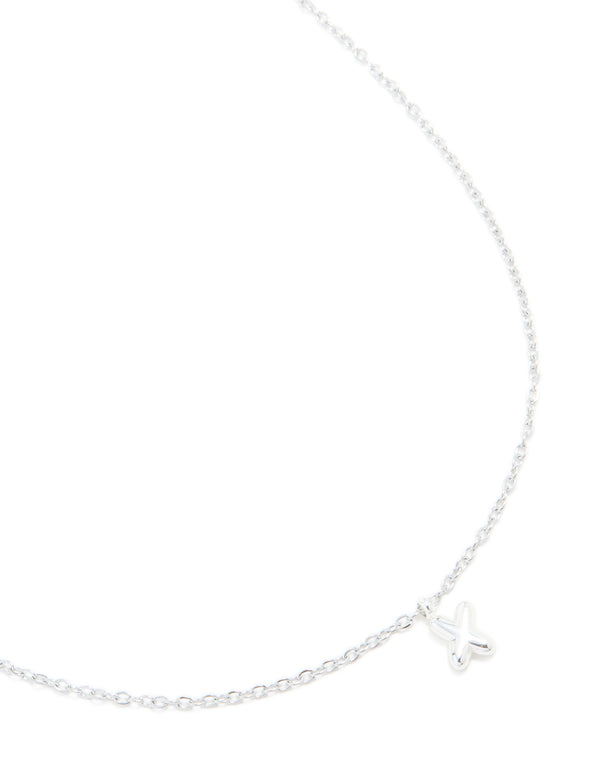 Showcasing a waterproof stainless steel mini bubble letter X necklace with initial pendant in silver close up view