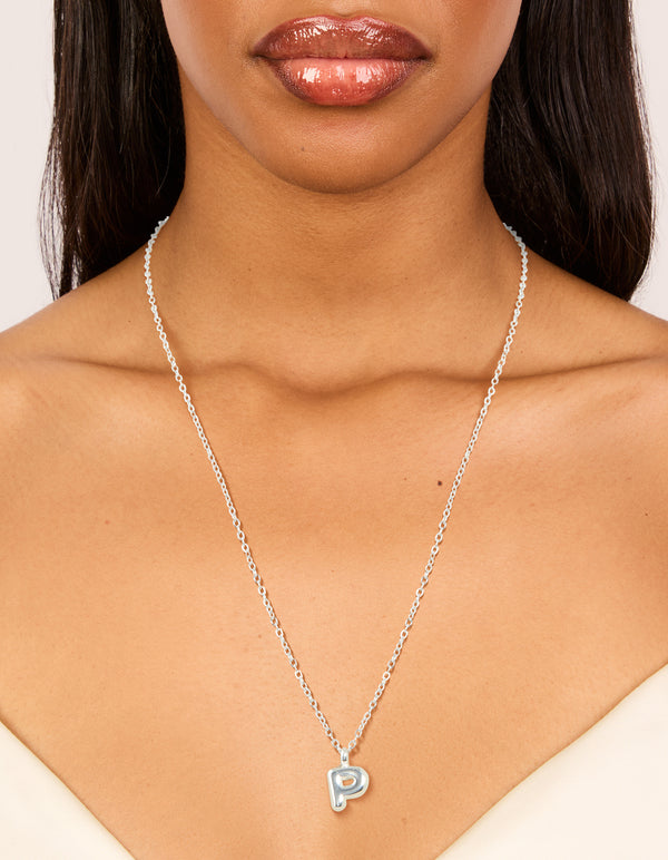 Featuring a waterproof stainless steel mini bubble letter P necklace with pendant and initial detail in dainty silver on neck view