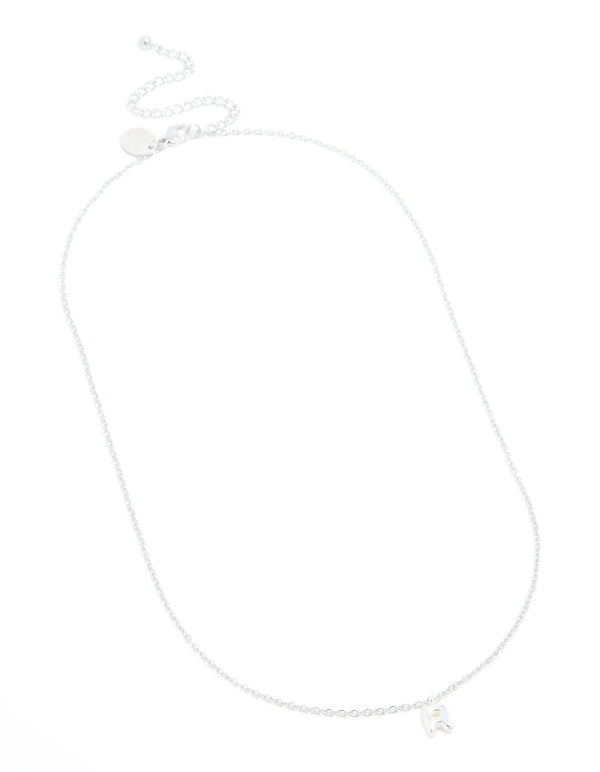 Featuring a waterproof stainless steel mini bubble letter R necklace with initial pendant in silver and dainty styling close up view