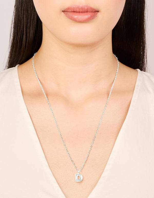 Discover this waterproof stainless steel mini bubble letter D necklace with initial featuring pendant in silver on neck view