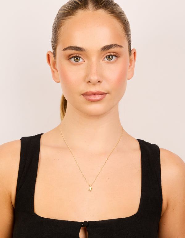 Discover a waterproof bubble letter X initial pendant necklace crafted from gold plated stainless steel on model view