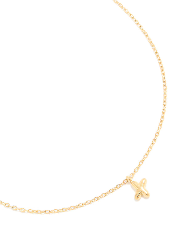 Showcasing a waterproof bubble letter X charm initial pendant necklace crafted from gold plated stainless steel close up view