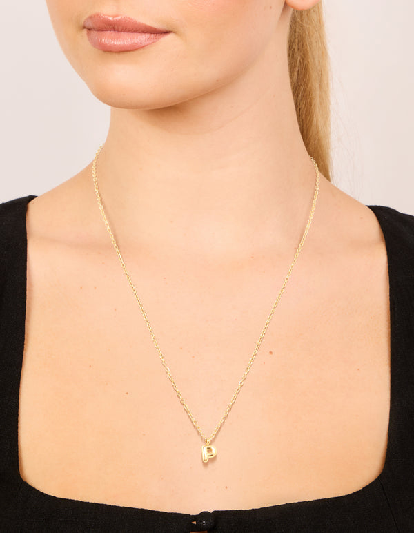 Showcasing a waterproof gold plated stainless steel mini bubble letter P initial pendant necklace on neck view