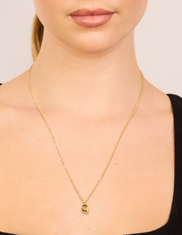 Designed with waterproof gold plated stainless steel mini bubble letter Q initial pendant necklace s on neck view