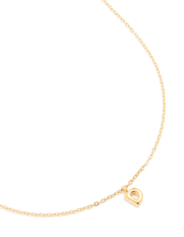 Featuring a waterproof bubble letter D charm necklace in gold plated stainless steel with dainty pendant close up view