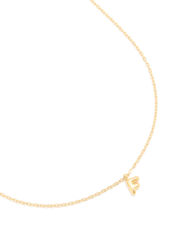 Showcasing a waterproof bubble letter F initial pendant necklace crafted from stainless steel with gold plated finish close up view
