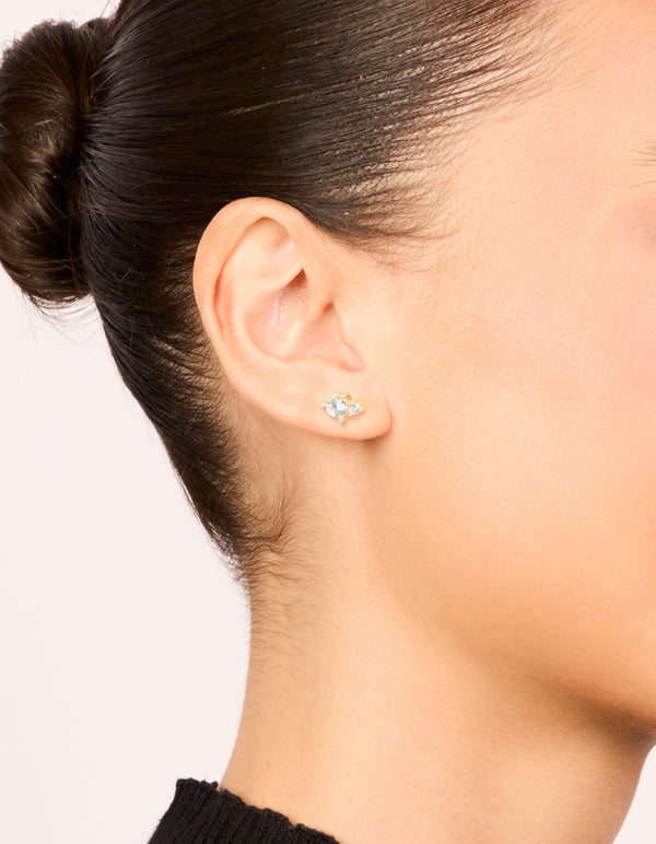 Designed with gold plated stainless steel and round cubic zirconia stones, these waterproof duo stud earrings are shown on ear view