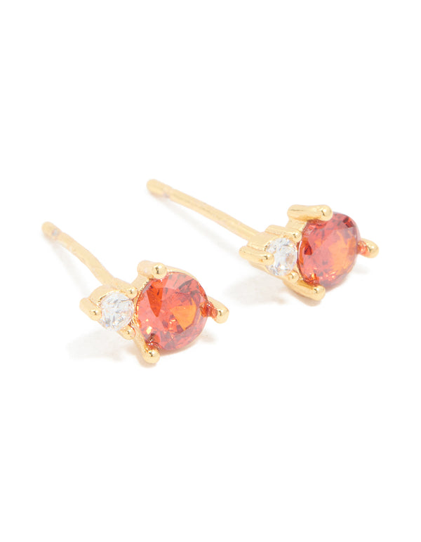Showcasing waterproof stainless steel dainty stud earrings with coral and clear cubic zirconia stones in gold plated finish front view