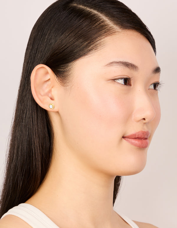 Discover waterproof gold plated stainless steel pearl bezel set stud earrings in white on model view