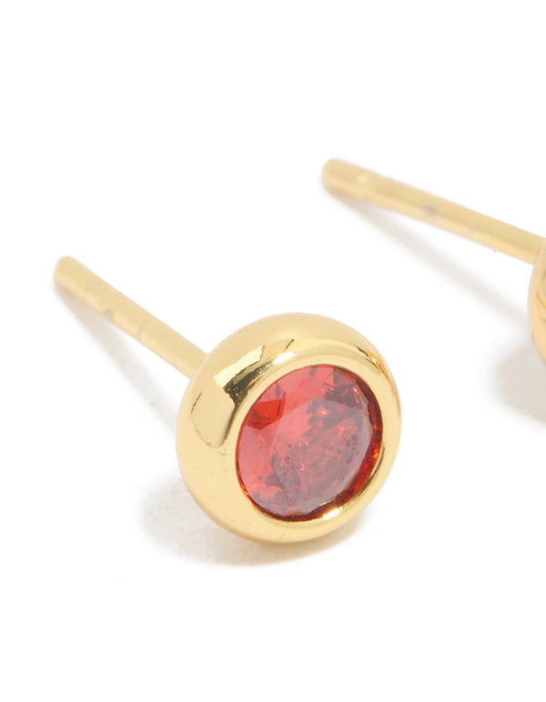 Crafted from waterproof stainless steel cubic zirconia January birthstone bezel set stud earrings with round stone cut in gold and crimson close up view