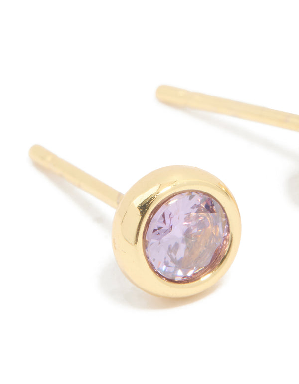 Expertly designed waterproof bezel set stud earrings with lavender cubic zirconia stones and gold plated stainless steel finish close up view