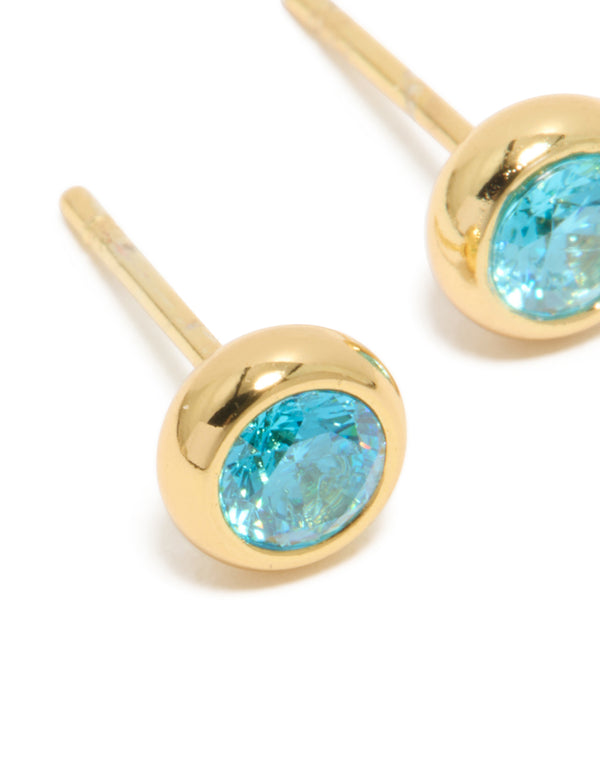 Highlighting waterproof gold plated stainless steel aquamarine cubic zirconia March birthstone bezel set stud earrings close up view