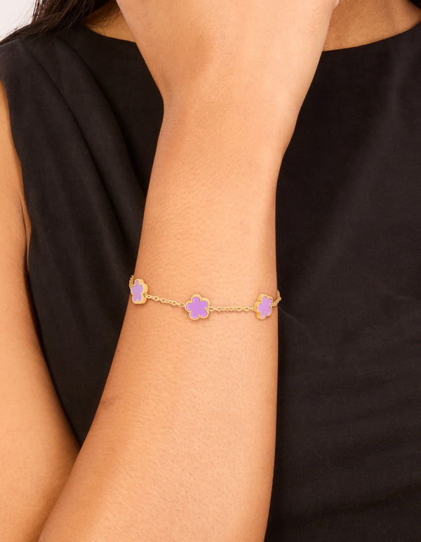Designed with waterproof gold plated stainless steel, this light purple petal flower charm bracelet in plum on wrist view