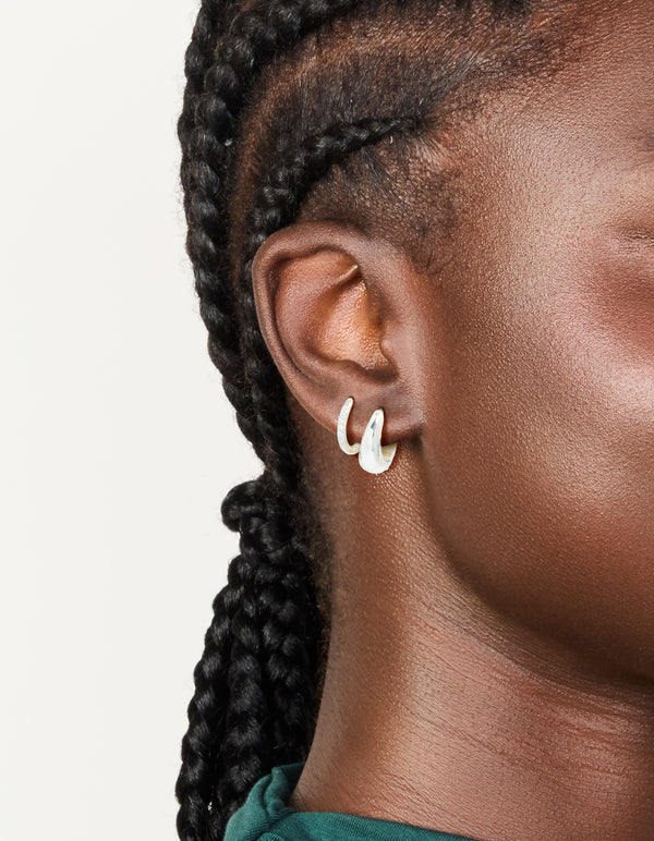 Showcasing waterproof stainless steel cubic zirconia and chubby huggie earrings 2-pack with crystal silver chunky on ear view