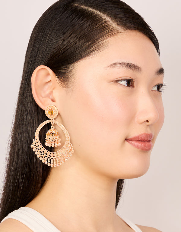 Designed with gold circle boho drop earrings featuring beads and charm on model view