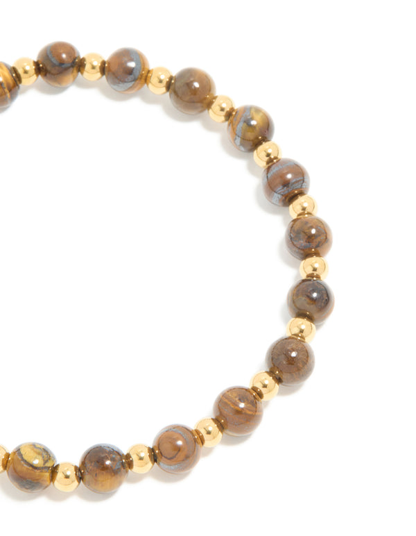 Highlighting a waterproof gold plated stainless steel tiger's eye semi precious stone beaded stretch bracelet close up view