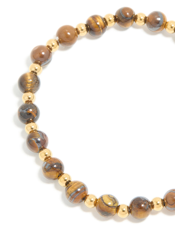 Highlighting a waterproof gold plated stainless steel tiger's eye semi precious stone beaded stretch bracelet close up view