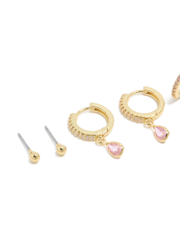 Showcasing dainty earrings with gold plated brass, cubic zirconia, and pink tourmaline October birthstone in a 4-pack set featuring balls stud and huggie closures close up view